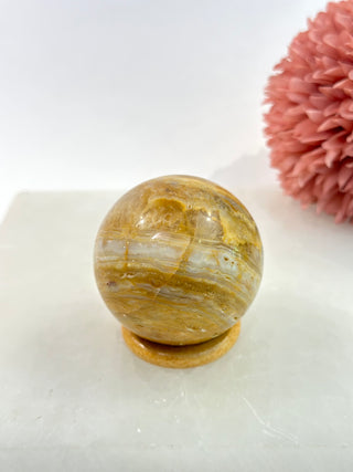 Yellow Lace Agate Sphere has properties of the colour yellow, which include increased willpower, concentration, memory and logic. It is well known for its calming, soothing effects on the mind.